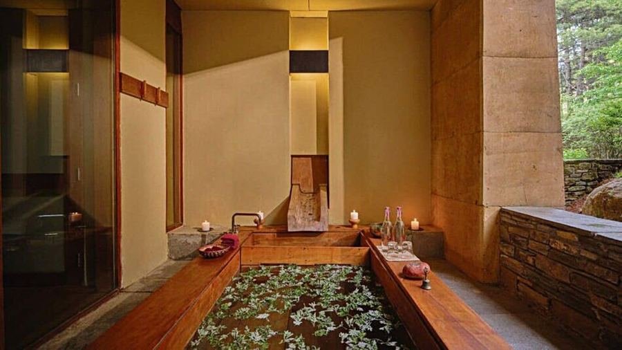 Aman Spa treatment room with a stone bath