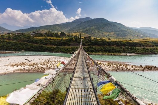 Punakha suspension bridge draped with prayer flags