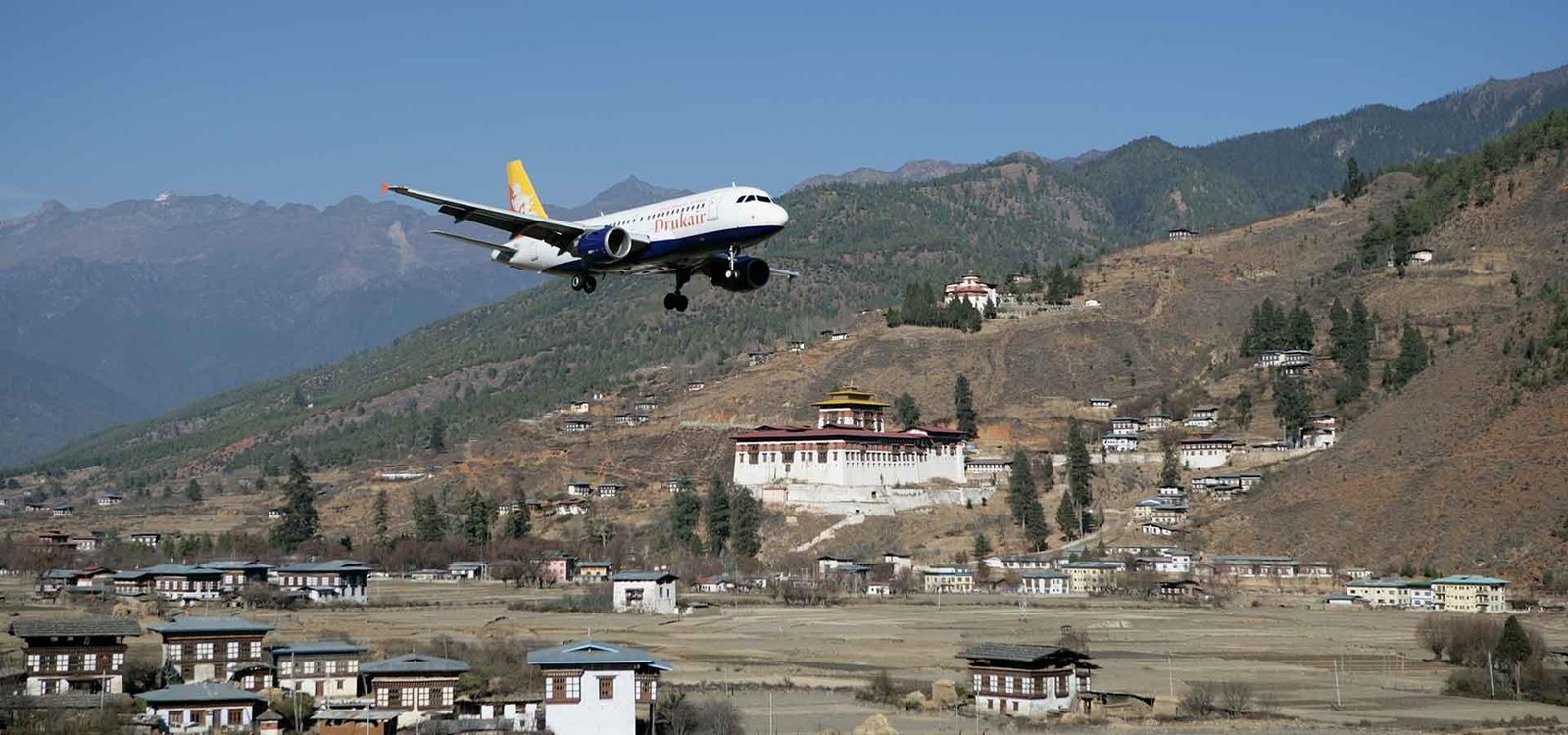 Aircraft landing at Paro International Airport between the mountains