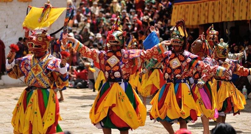 Masked cham dancers at a Bhutanese tshechu festival