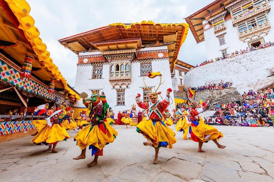 Masked cham dancers at a Bhutanese festival