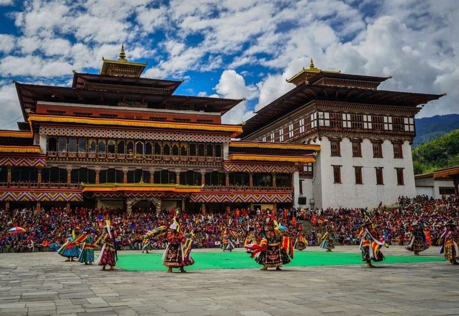 Cham dances in a dzong courtyard before a large crowd