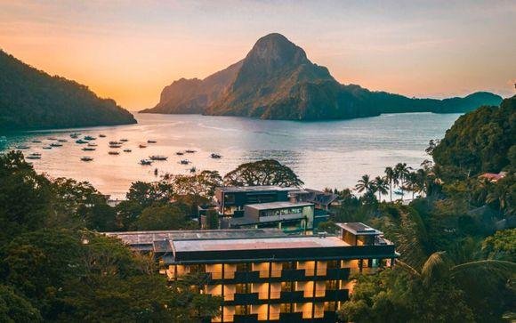 Resort above Coron Bay at sunset with limestone islands beyond