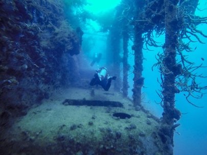 Diver exploring the interior structure of a sunken ship