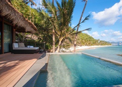 Infinity pool and villa deck facing the beach at an El Nido island resort