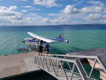 Seaplane moored at a jetty in turquoise water, Palawan