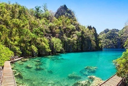Clear emerald water and boardwalk at Kayangan Lake