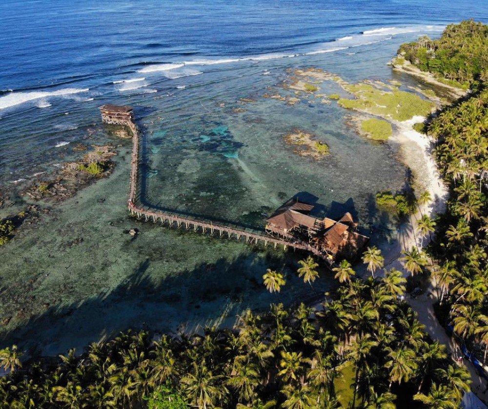 Aerial view of the Cloud 9 boardwalk and viewing tower reaching over the reef at Siargao